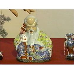 Old, Chinese Famille Rose enameled porcelain figure of seated Shou Lao with staff and peach (minor w