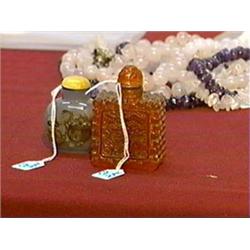 Two Chinese snuff bottles: well-hollowed "cameo" agate with pomegranate design, ivory stopper; and a