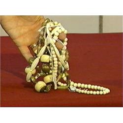 Lot of four various bead necklaces: two ivory, one bone and metal and one horn
