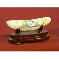 Well-detailed, scrimmed whale's tooth with sailing ship design, inscriptions, wood stand