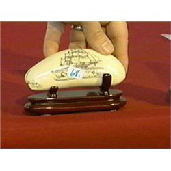 Scrimmed whale's tooth with well-detailed sailing ship and whale motif, wood stand