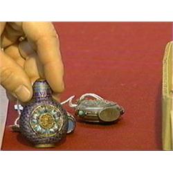 Three old snuff bottles: two Chinese cloisonné and enameled; and a Mongolian "jeweled" repousse silv