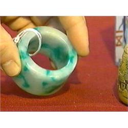 Large Chinese, carved jadeite "archer's ring"-form object with some apple-green coloration (probably