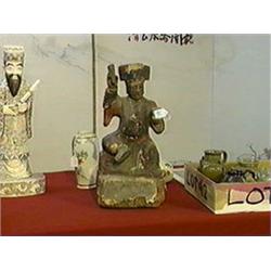 Chinese, late Ming Dynasty, carved and lacquered wood temple figure holding a book and a cup (flaws)
