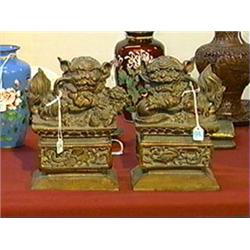 Pair of finely carved and detailed, antique Chinese red and gold lacquered wood models of lions on p