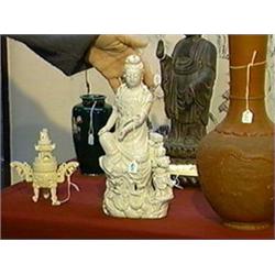 Old and well-detailed, Chinese Blanc-de-Chine porcelain figure of Kwan Yin seated on rockery in "roy