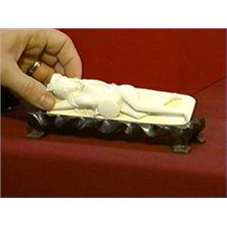 Small, old Chinese carved ivory doctor's lady reclining with fan (chips), on wood stand