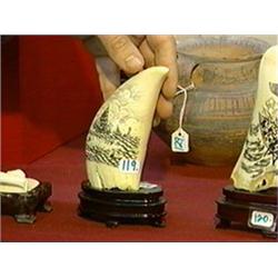 Very well-detailed, scrimmed whale's tooth with whaling scenes on both sides (minor split), wood sta