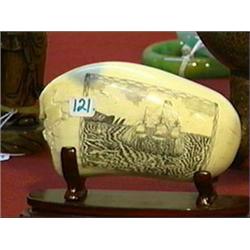 Well-detailed, scrimmed whale's tooth with sailing ship and whale design, wood stand