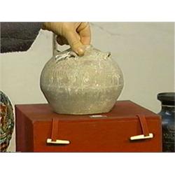 Chinese, early Han Dynasty, pottery jar with four strap handles and incised geometric designs