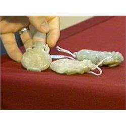 Group of three, Chinese jade/hardstone objects: greyish-green pendant with squirrel on grapes, beige