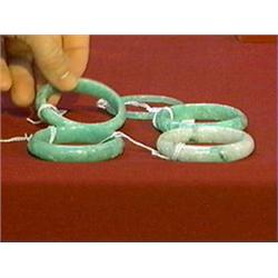 Group of five, Chinese carved apple-green and pale green jadeite bangle bracelets (all probably colo