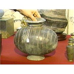 Chinese, Han Dynasty, dark pottery "cocoon" jar with incised vertical line design (chips and repairs