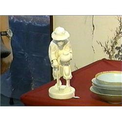 Well-carved and superbly detailed, African ivory figure of a man with walking stick and pot (split t