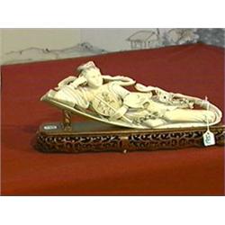 Finely carved and detailed, older Chinese ivory figure of a reclining celestial beauty holding a fan