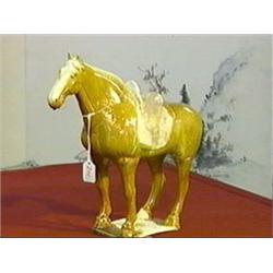 Very finely modeled and with unusually bright amber and straw glaze, Chinese T'ang Dynasty, pottery 