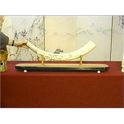 Well-carved and very elaborately detailed, African ivory tusk/bridge with lions and gazelles amid tr