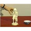 Image 1 : Well-carved and highly detailed, African carved ivory figure of a hunter carrying his kill (split to