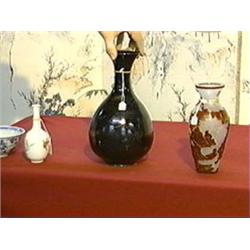 Chinese, evenly Honan glazed, bottle vase of good form with iron-rust stylized floral designs, proba