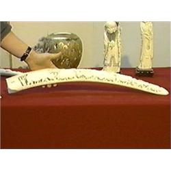 African, carved ivory tusk/bridge with design of rhinos and water buffalo (minor cracks and chips), 
