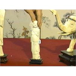 Well-carved, Chinese ivory figure of standing Putai holding an openwork staff, wood stand
