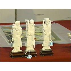 Group of three, small Chinese carved ivory figures of gods, good detailing, wood stands