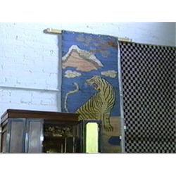 Old, Sino-Tibetan wool rug with design of ferocious tiger in landscape (some flaws and wear)