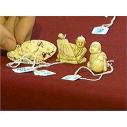 Three small ivory carvings: two old marine (whale's tooth) figural netsuke; and a brooch plaque with