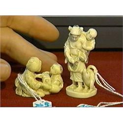 Two charming, well-carved and detailed, ivory netsuke of women with their children: one walking with