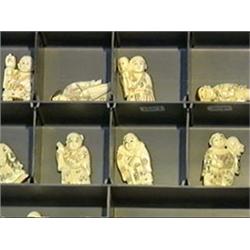 Group of twenty-five, carved ivory netsuke of figures in various pursuits, some lightly polychromed,