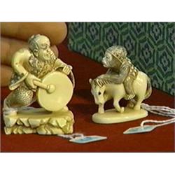 Two carved and lightly polychromed, ivory netsuke: monkey on horseback, signed; and man with gong on