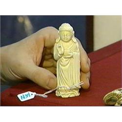 Small, Chinese carved and stained ivory figure of standing Buddha holding an alms bowl