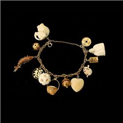 14K YELLOW GOLD, SILVER GILT CHARM BRACELET.