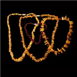 COLLECTION OF FOUR AMBER BEAD NECKLACES.