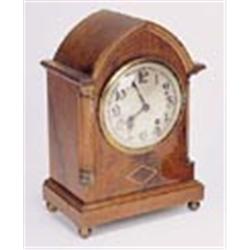 An Edwardian mahogany and pale-wood-banded lancet mantel clock, the eight day two-train movement str