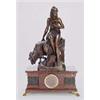 Image 1 : A French red marble mantel clock surmounted with a statue; the eight day two-train movement striking
