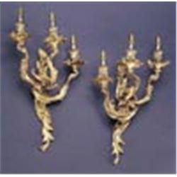 A pair of 19th century wall lights, each in rococo style cast with foliate scrolls of three branches