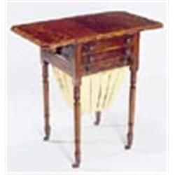 A George IV mahogany and rosewood crossbanded work table, the boxwood strung canted rectangular top