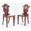 Image 1 : A pair of Regency mahogany hall chairs, in the manner of Tatham, each with a scroll carved shield sh