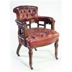 A late Victorian oak tub shaped library chair by James Shoolbred & Co, with red Morocco leather butt