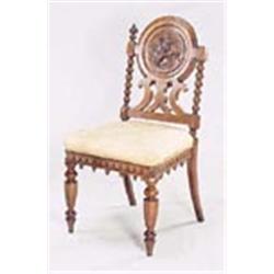 A Victorian oak hall chair, the round back carved with  three fish on turned supports with lobed fin