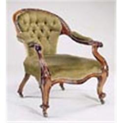 A Victorian rosewood open armchair, the crest carved with flower heads, with padded back, arms and s