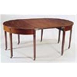 A late George III mahogany 'D' end dining table, with one loose leaf, the frieze with boxwood string