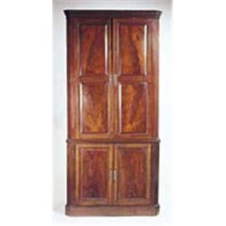 A George III mahogany standing corner cupboard, the dentil cornice above two double panelled doors e