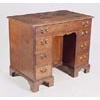 Image 1 : A George III oak kneehole desk, the rectangular top with moulded edge above seven drawers with later