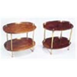 Two similar mahogany oval two tier tables, each of oval form with brass galleries, finials and tubul