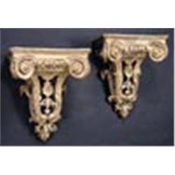 Two 18th century giltwood wall brackets, carved with scrolls and egg and dart borders, above a shell