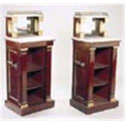 A pair of Regency mahogany and parcel gilt small open bookcases, each with a mirrored raised back, m