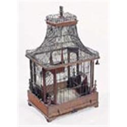 A wirework and mahogany rectangular bird cage, in Chinese style with pagoda type top, the sides with