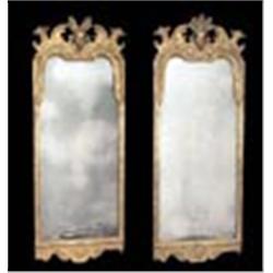 A pair of wall mirrors, each giltwood and gesso frame with flowers and leaf scrolls on an incised gr